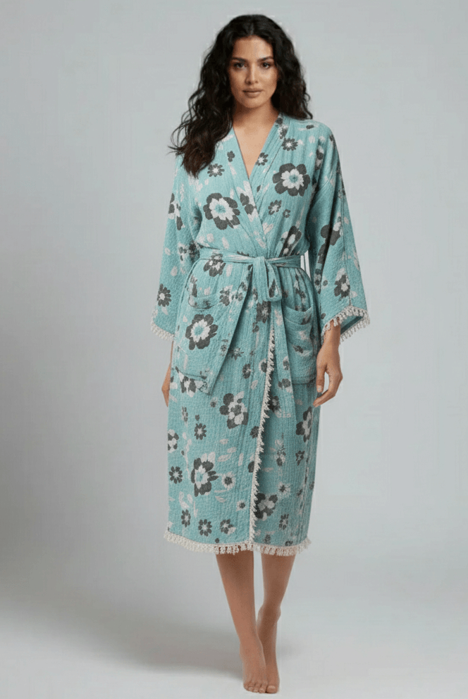 Woman wearing a floral patterned robe on a plain background