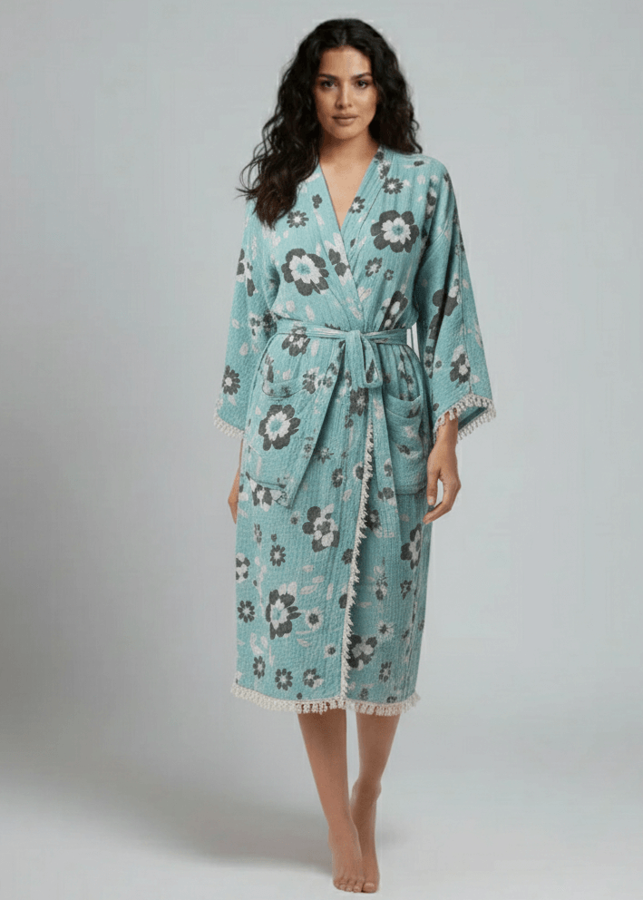 Woman wearing a floral patterned robe on a plain background