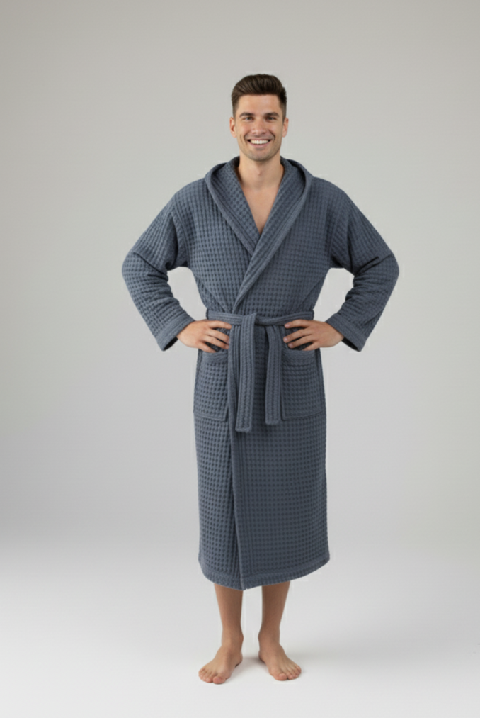 Man wearing a blue navy waffle robe on a white background