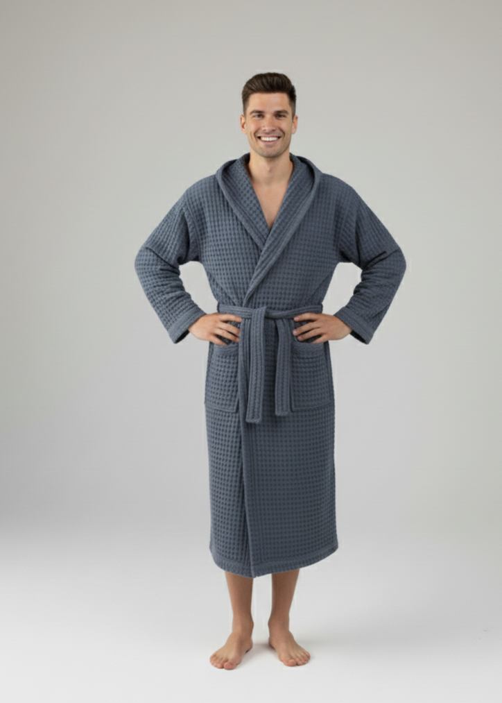 Man wearing a blue navy waffle robe on a white background